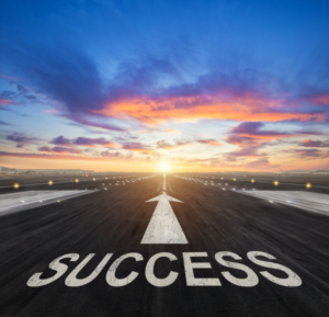 The word success on an airport runway