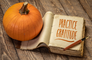 Image of gratitude journal and pumpkin