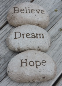 A line of rocks that say believe, dream, hope